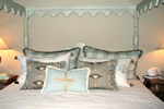 white wood canopy bed.